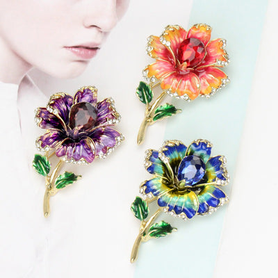 Piper Enamel Primrose Brooch - A detailed floral brooch featuring a large central stone with ruffled enamel petals surrounding it, painted with vibrant enamel paint.