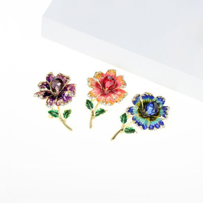 Piper Enamel Primrose Brooch - A detailed floral brooch featuring a large central stone with ruffled enamel petals surrounding it, painted with vibrant enamel paint.