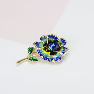 Piper Enamel Primrose Brooch - A detailed floral brooch featuring a large central stone with ruffled enamel petals surrounding it, painted with vibrant enamel paint.