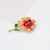 Piper Enamel Primrose Brooch - A detailed floral brooch featuring a large central stone with ruffled enamel petals surrounding it, painted with vibrant enamel paint.