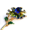 Piper Enamel Primrose Brooch - A detailed floral brooch featuring a large central stone with ruffled enamel petals surrounding it, painted with vibrant enamel paint.