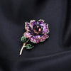 Piper Enamel Primrose Brooch - A detailed floral brooch featuring a large central stone with ruffled enamel petals surrounding it, painted with vibrant enamel paint.