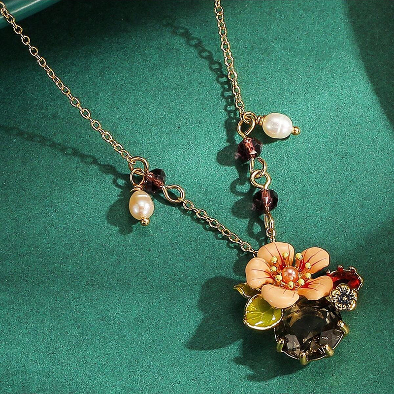The Pretty Posy Enamel Necklace - A delicate floral pendant in an unusual shade of orange.