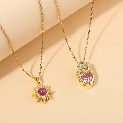 Pretty Pretty Princess Royal Heart & Sun Necklace Set - A delicate jewellery set featuring a matched pair of necklaces with pink crystals and gold-toned metal.