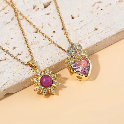 Pretty Pretty Princess Royal Heart & Sun Necklace Set - A delicate jewellery set featuring a matched pair of necklaces with pink crystals and gold-toned metal.