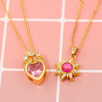 Pretty Pretty Princess Royal Heart & Sun Necklace Set - A delicate jewellery set featuring a matched pair of necklaces with pink crystals and gold-toned metal.
