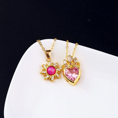Pretty Pretty Princess Royal Heart & Sun Necklace Set - A delicate jewellery set featuring a matched pair of necklaces with pink crystals and gold-toned metal.