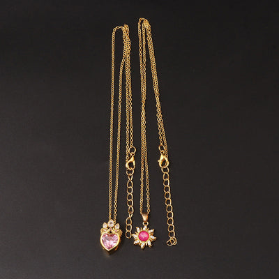 Pretty Pretty Princess Royal Heart & Sun Necklace Set - A delicate jewellery set featuring a matched pair of necklaces with pink crystals and gold-toned metal.