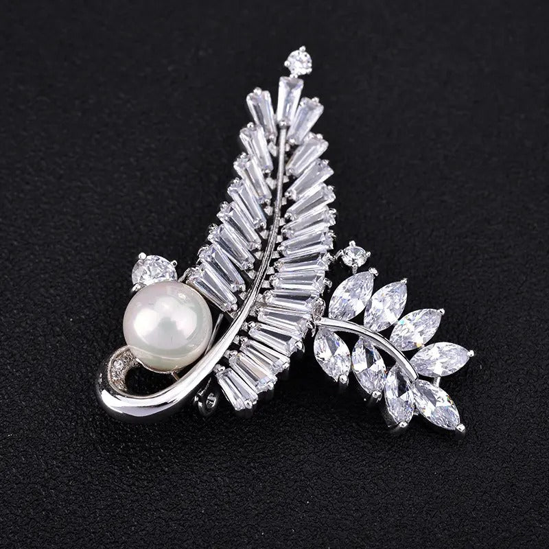 Radiance Luxury Crystal Looped Fern Brooch - A lovely sparkling crystal brooch featuring two beautiful fern fronds joined by a gentle twist and accented with a single pearl. 