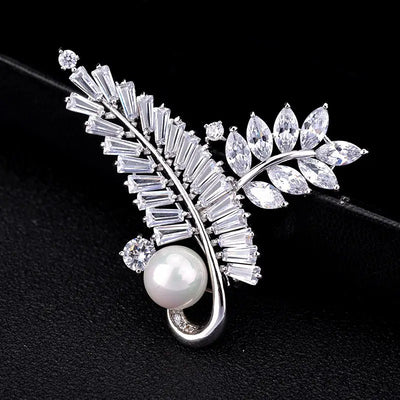 Radiance Luxury Crystal Looped Fern Brooch - A lovely sparkling crystal brooch featuring two beautiful fern fronds joined by a gentle twist and accented with a single pearl.