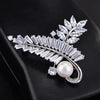 Radiance Luxury Crystal Looped Fern Brooch - A lovely sparkling crystal brooch featuring two beautiful fern fronds joined by a gentle twist and accented with a single pearl.