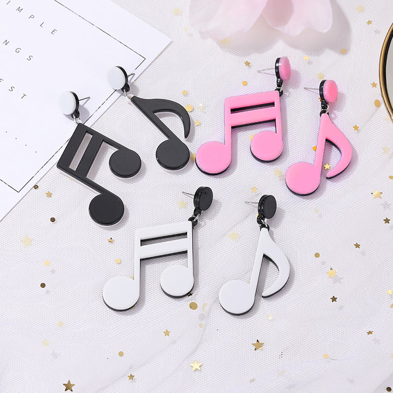 Retro Revival Notable Notes Earrings - Large asymmetrical acrylic earrings shaped like oversized musical notes, created from stylized pink, white, or black acrylic.