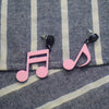 Retro Revival Notable Notes Earrings - Large asymmetrical acrylic earrings shaped like oversized musical notes, created from stylized pink, white, or black acrylic.