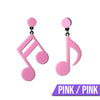 Retro Revival Notable Notes Earrings - Large asymmetrical acrylic earrings shaped like oversized musical notes, created from stylized pink, white, or black acrylic.