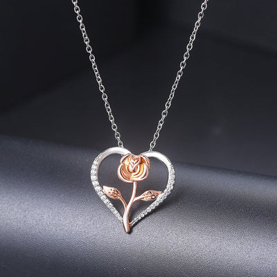 Rosalie Rosebud Heart Necklace - An elegant floral-themed necklace featuring a platinum plated heart with a beautiful rose gold rose, and sparkling crystals.