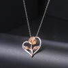 Rosalie Rosebud Heart Necklace - An elegant floral-themed necklace featuring a platinum plated heart with a beautiful rose gold rose, and sparkling crystals.