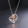 Rosalie Rosebud Heart Necklace - An elegant floral-themed necklace featuring a platinum plated heart with a beautiful rose gold rose, and sparkling crystals.