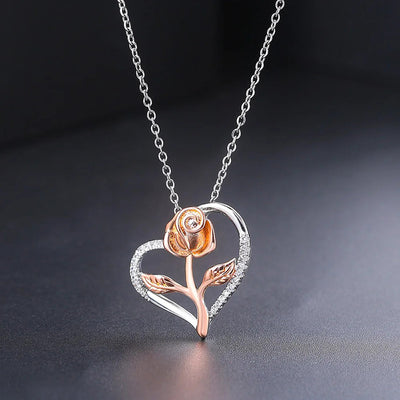 Rosalie Rosebud Heart Necklace - An elegant floral-themed necklace featuring a platinum plated heart with a beautiful rose gold rose, and sparkling crystals.