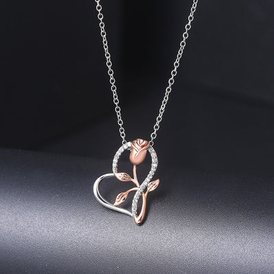 Rosalie Rosebud Heart Necklace - An elegant floral-themed necklace featuring a platinum plated heart with a beautiful rose gold rose, and sparkling crystals.