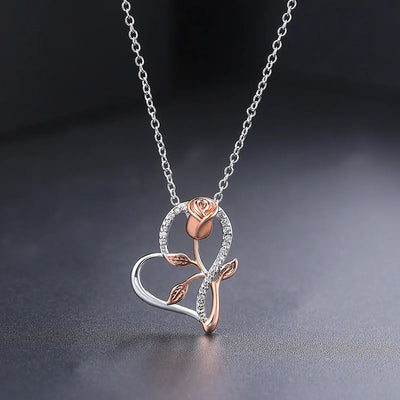 Rosalie Rosebud Heart Necklace - An elegant floral-themed necklace featuring a platinum plated heart with a beautiful rose gold rose, and sparkling crystals.