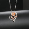 Rosalie Rosebud Heart Necklace - An elegant floral-themed necklace featuring a platinum plated heart with a beautiful rose gold rose, and sparkling crystals.