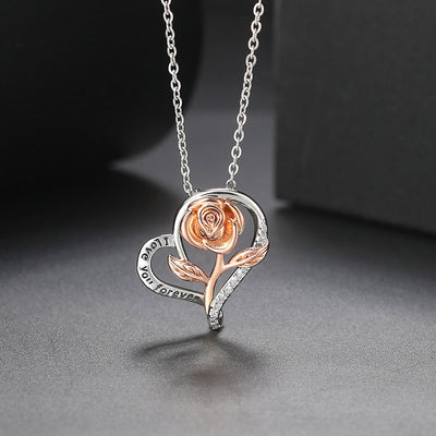 Rosalie Rosebud Heart Necklace - An elegant floral-themed necklace featuring a platinum plated heart with a beautiful rose gold rose, and sparkling crystals.