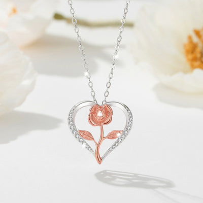 Rosalie Rosebud Heart Necklace - An elegant floral-themed necklace featuring a platinum plated heart with a beautiful rose gold rose, and sparkling crystals.