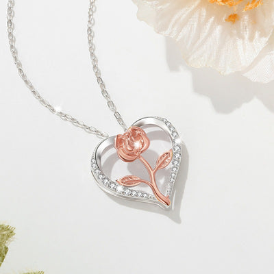 Rosalie Rosebud Heart Necklace - An elegant floral-themed necklace featuring a platinum plated heart with a beautiful rose gold rose, and sparkling crystals.