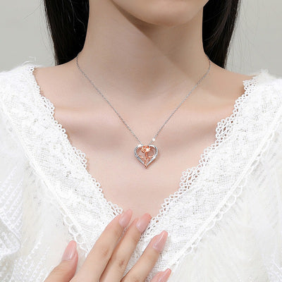 Rosalie Rosebud Heart Necklace - An elegant floral-themed necklace featuring a platinum plated heart with a beautiful rose gold rose, and sparkling crystals.