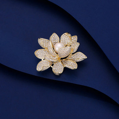 Sadira Crystal Lotus Brooch - An elegant flower brooch featuring an array of jewel-encrusted petals surrounding a central pearl.