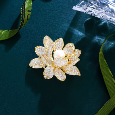 Sadira Crystal Lotus Brooch - An elegant flower brooch featuring an array of jewel-encrusted petals surrounding a central pearl.