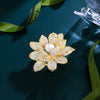 Sadira Crystal Lotus Brooch - An elegant flower brooch featuring an array of jewel-encrusted petals surrounding a central pearl.