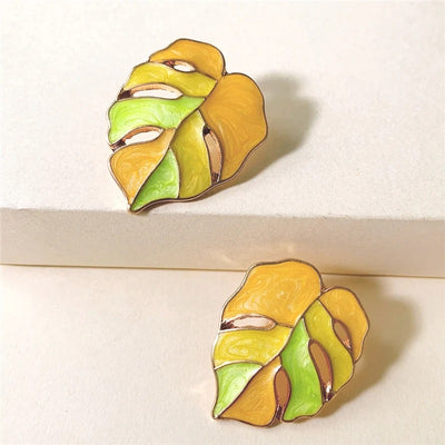 Salma Palm Leaf Enamel Earrings - Large enamel earrings with stylised leaves painted in complimentary shades of enamel paint.