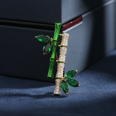 Sasae Crystal Bamboo Brooch - An elegant green brooch designed to look like a pair of stylised bamboo stalks, adorned with green and white crystals.