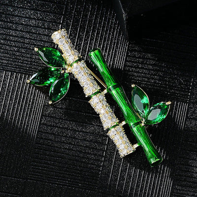 Sasae Crystal Bamboo Brooch - An elegant green brooch designed to look like a pair of stylised bamboo stalks, adorned with green and white crystals.