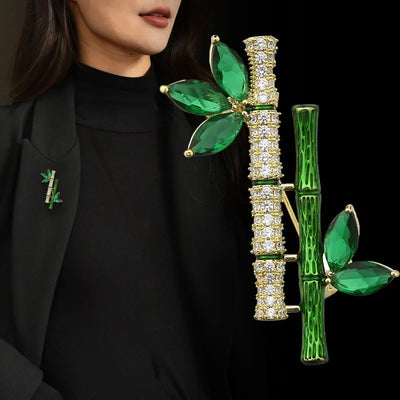 Sasae Crystal Bamboo Brooch - An elegant green brooch designed to look like a pair of stylised bamboo stalks, adorned with green and white crystals.
