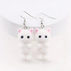 Selina Flocked Velvet Kitten Drop Earrings - Adorable little fuzzy humanoid kitty cat charms suspended from a French hook, available in your choice of grey, white, or pink.