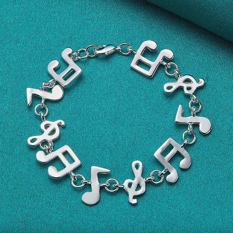 Shania Music Note Charm Bracelet - A lovely sterling silver brooch featuring a combination of stylised music notes strung together end to end.