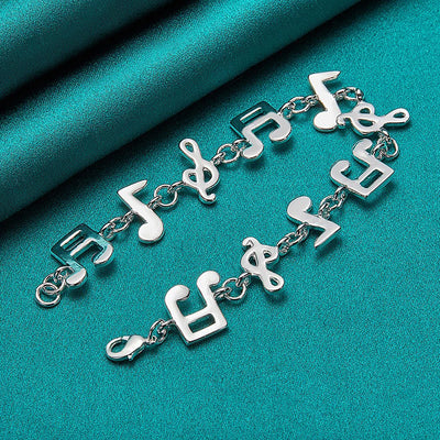 Shania Music Note Charm Bracelet - A lovely sterling silver brooch featuring a combination of stylised music notes strung together end to end.