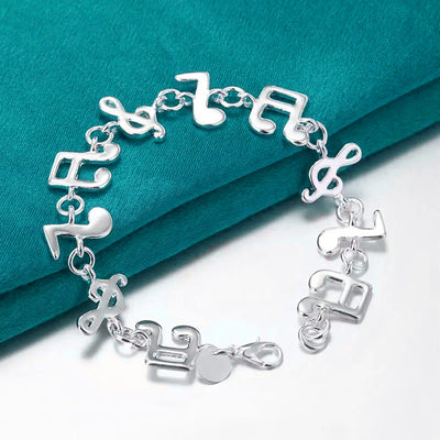 Shania Music Note Charm Bracelet - A lovely sterling silver brooch featuring a combination of stylised music notes strung together end to end.