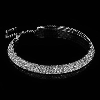 Shiara Luxury Crystal Choker - A close-fitting necklace with three layers of sparkling white crystals against a background of shiny silver-coloured metal.