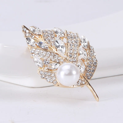 Sian Crystal Leaf Brooch - A medium-sized brooch shaped like a leaf, studded with assorted round and marquise cut crystals, and a pearl.