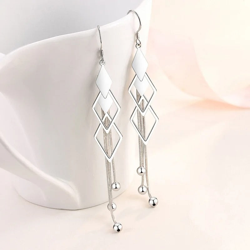 Sienna Dancing Threads Dangle Earrings - Lovely sterling silver earrings featuring interlocking diamonds and long elegant strands. 