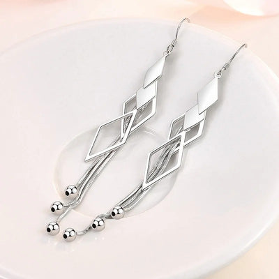 Sienna Dancing Threads Dangle Earrings - Lovely sterling silver earrings featuring interlocking diamonds and long elegant strands.