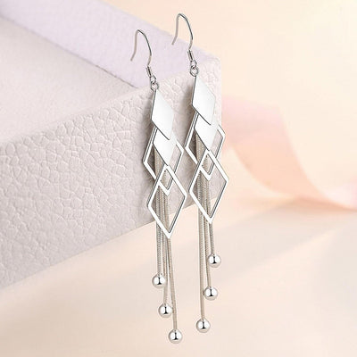 Sienna Dancing Threads Dangle Earrings - Lovely sterling silver earrings featuring interlocking diamonds and long elegant strands.