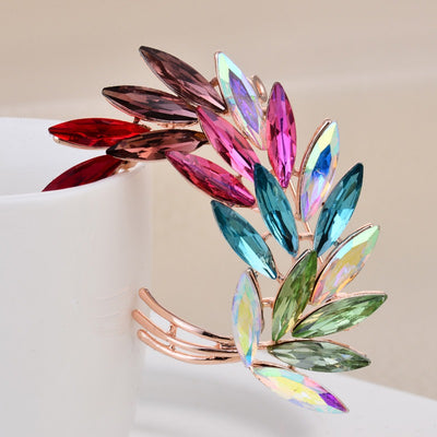 Sitaria Crystal Curved Grain Brooch - An elegant crystal brooch crafted from an assortment of marquise cut crystals arranged to look like heads of grain, in either a golden champagne colour or a rainbow gradient.