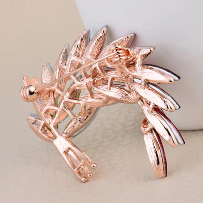 Sitaria Crystal Curved Grain Brooch - An elegant crystal brooch crafted from an assortment of marquise cut crystals arranged to look like heads of grain, in either a golden champagne colour or a rainbow gradient.