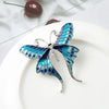 Skylar Long-Tail Butterfly Brooch - A lovely medium-sized butterfly brooch featuring colourful enamel and shiny artificial crystals. Available in your choice of blues or purple and green.