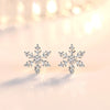 The Snow Queen II Jewellery Set - Crystal Tipped - A delicate snowflake-themed set of necklace and earrings, featuring snowflakes formed from textured silver with crystals set into the centre and tips.