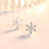 The Snow Queen II Jewellery Set - Crystal Tipped - A delicate snowflake-themed set of necklace and earrings, featuring snowflakes formed from textured silver with crystals set into the centre and tips.